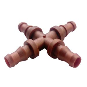 Cross-shaped plastic hose connector with four barbed ends for joining irrigation hoses.